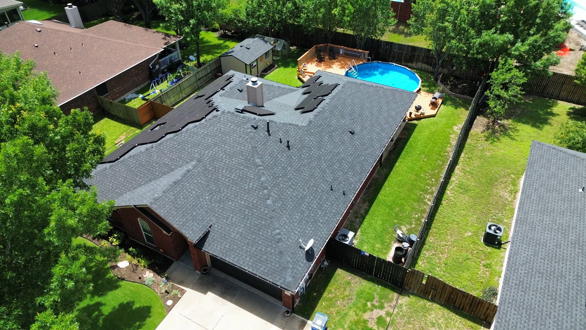 Brick ranch gray shingle roof above ground pool, Hutto, TX