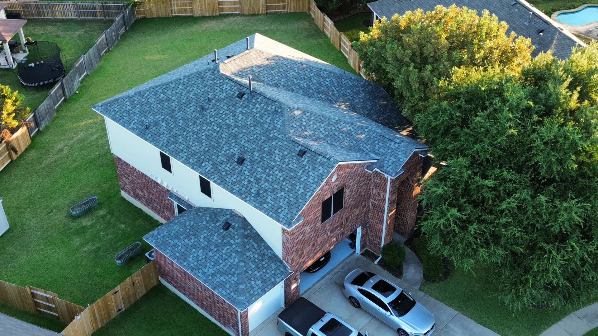 Garage hip roof blue gray shingles brick home, Hutto, TX