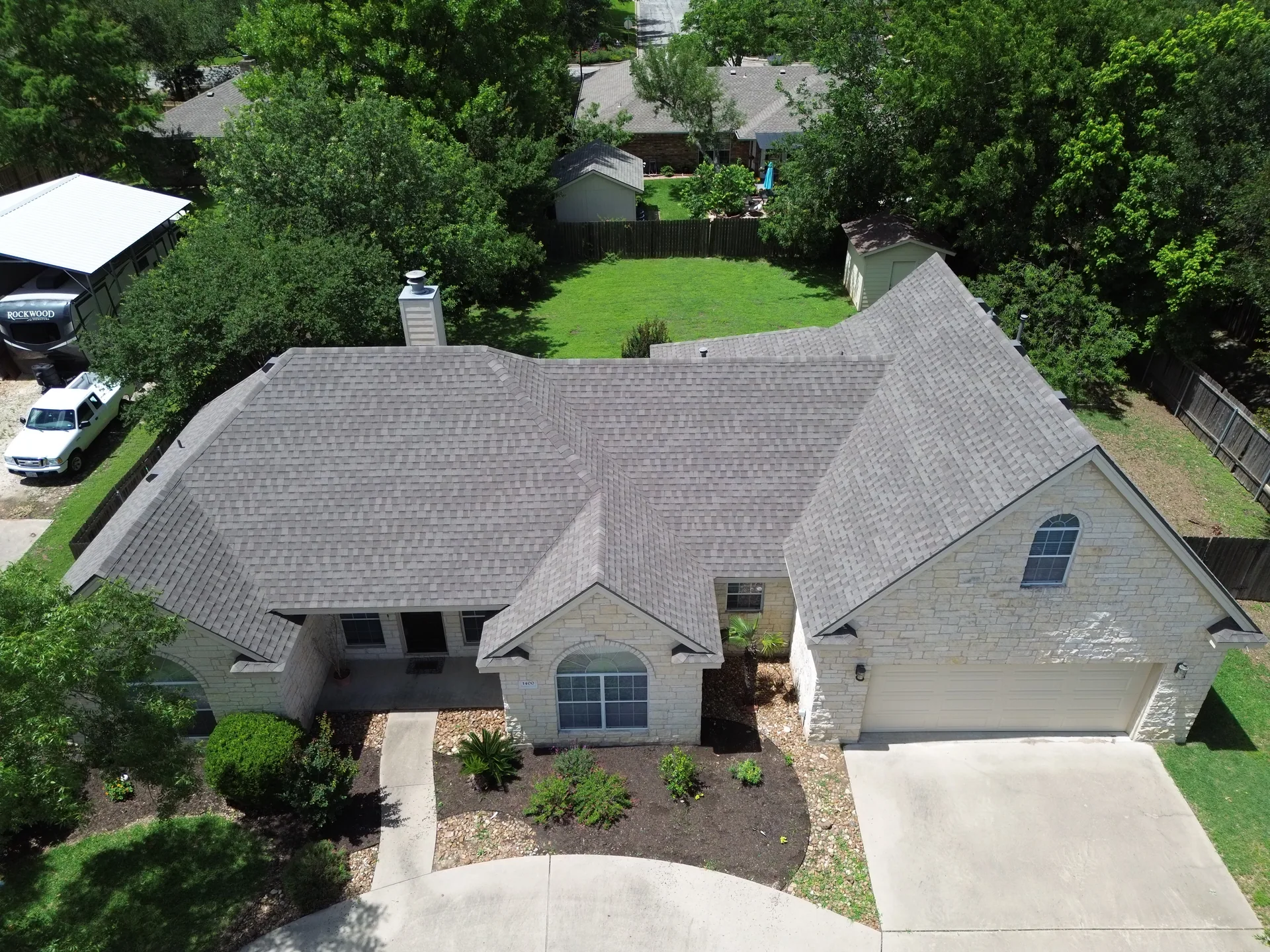 Limestone ranch home gray shingle roof, Hutto, TX