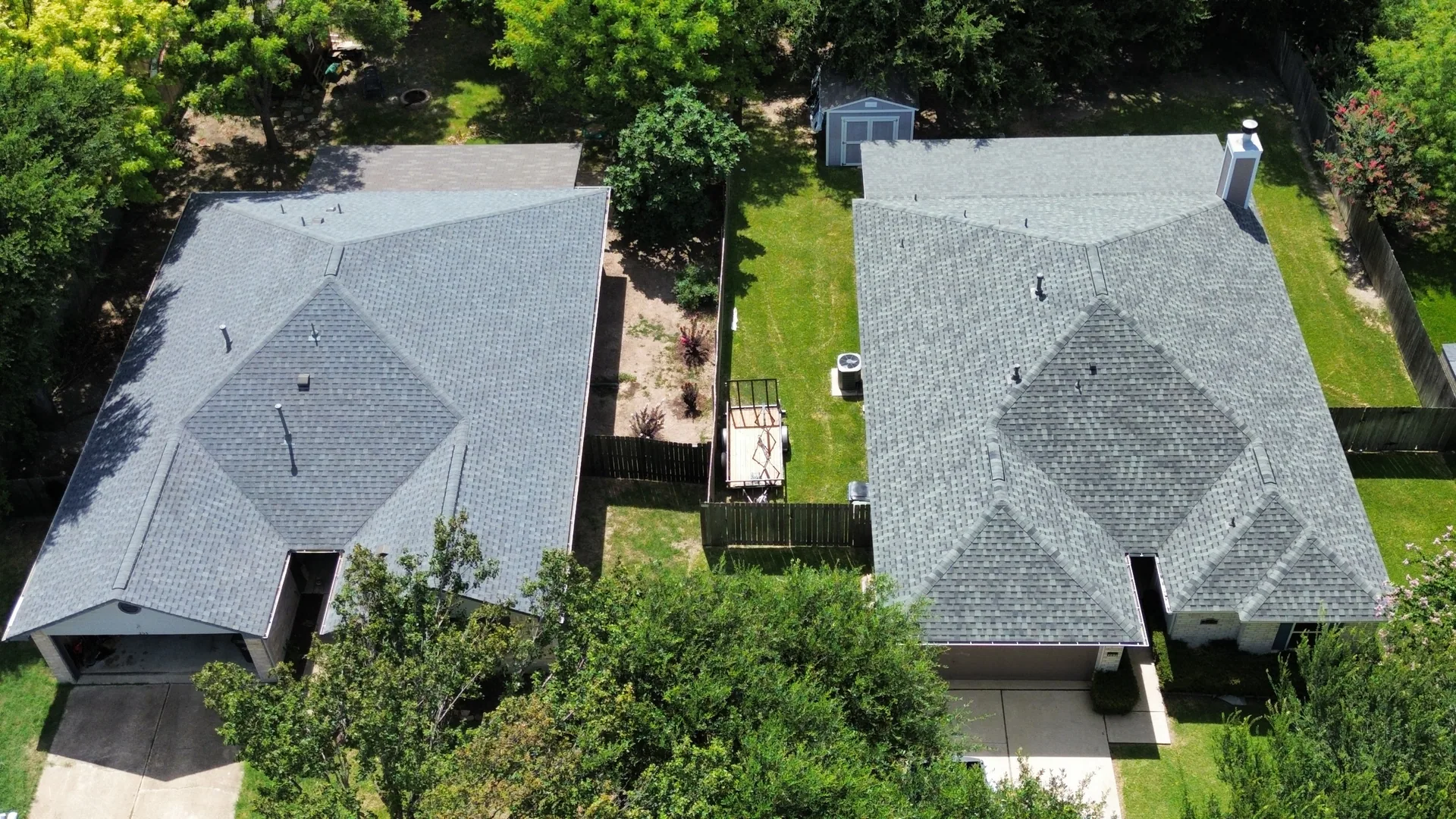 Neighboring homes gray shingle roofs, Hutto, TX