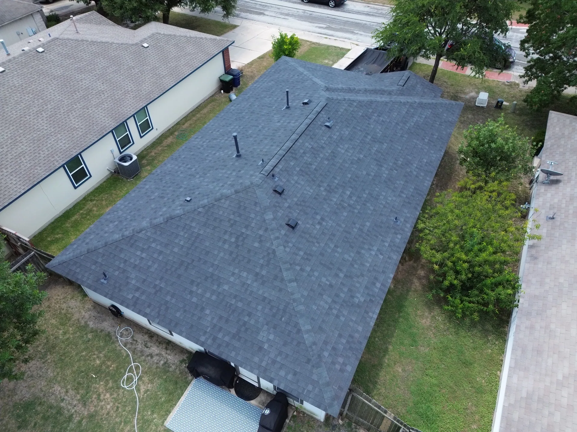 New charcoal shingle roof between homes, Hutto, TX